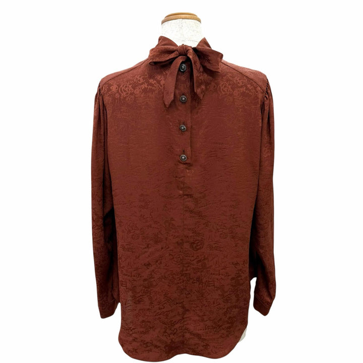 Excellent CHANEL blouse COCO Mark all-over print lion button bow tie silk FR 36