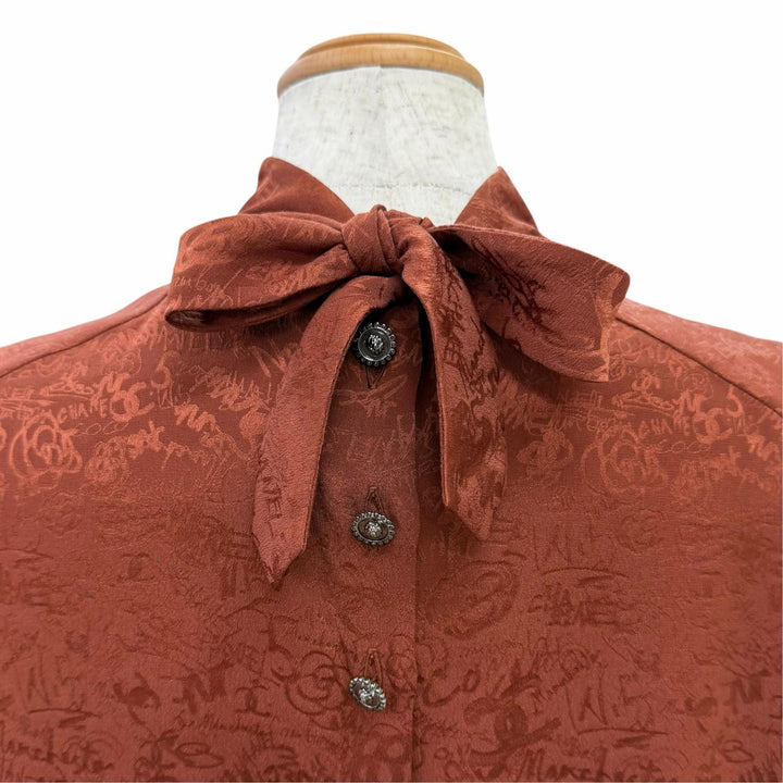 Excellent CHANEL blouse COCO Mark all-over print lion button bow tie silk FR 36